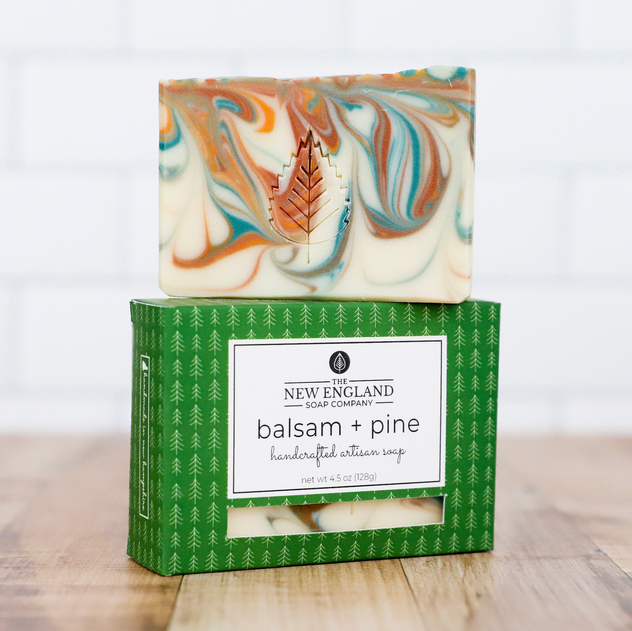 Marbled soap bar on top of a green box with &
