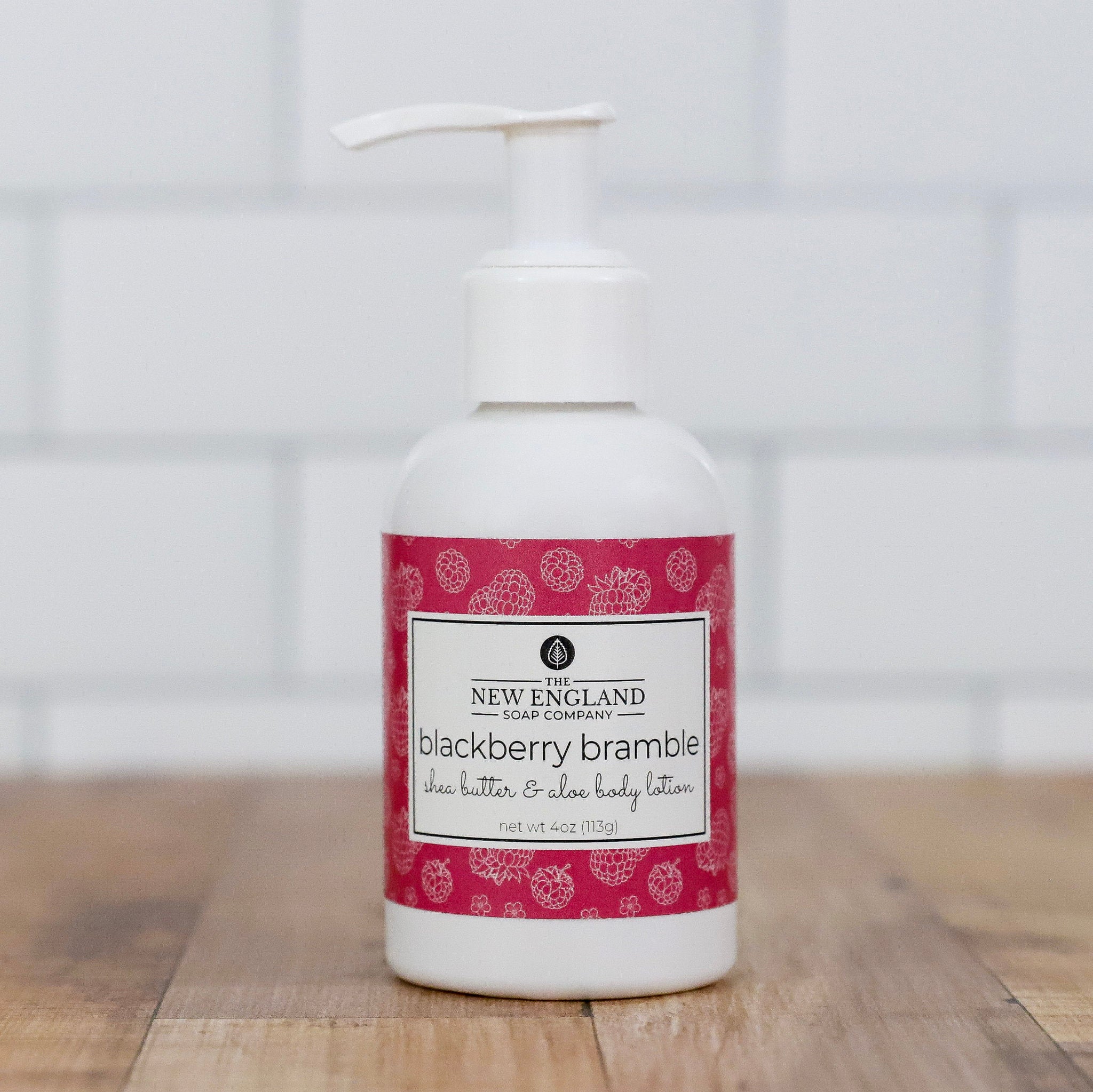 Body lotion bottle with a red label on a wooden surface