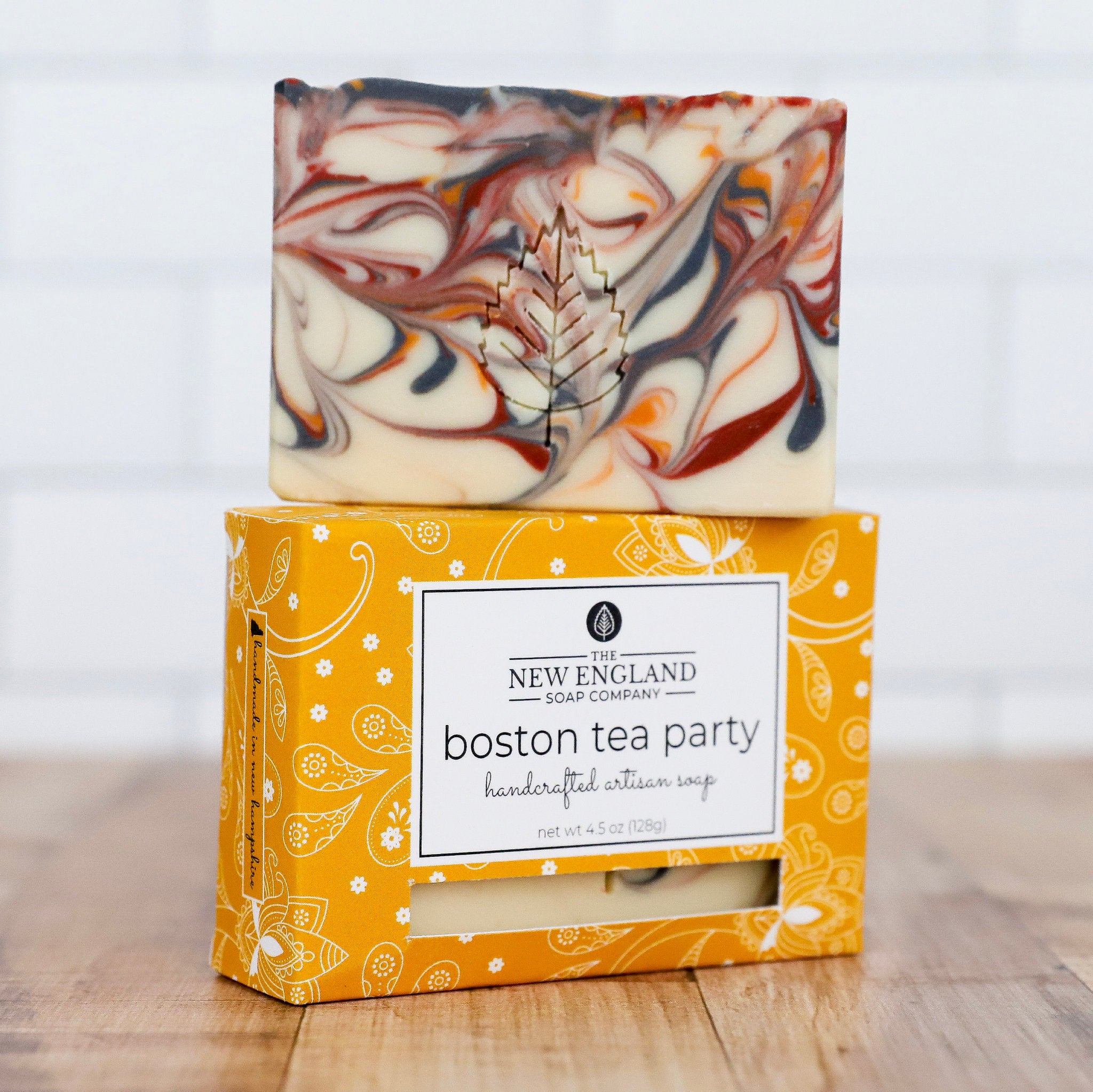 Marbled soap bar on top of a decorative box with &
