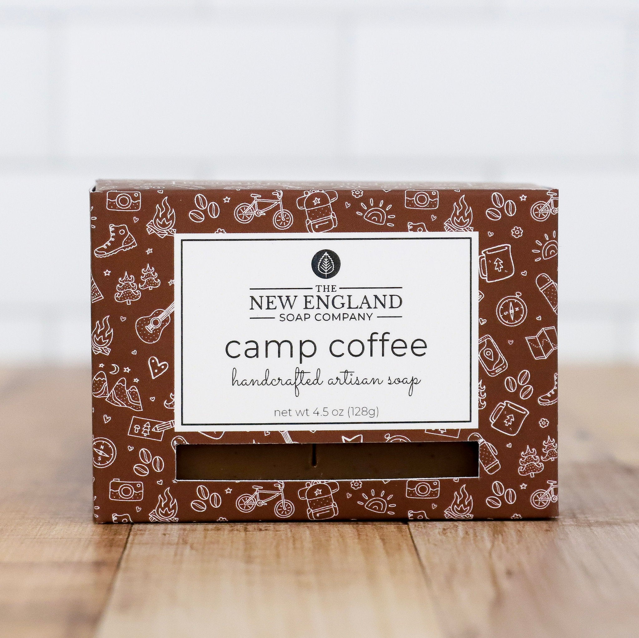 Box of New England Soap Company camp coffee soap on a wooden surface with a white background
