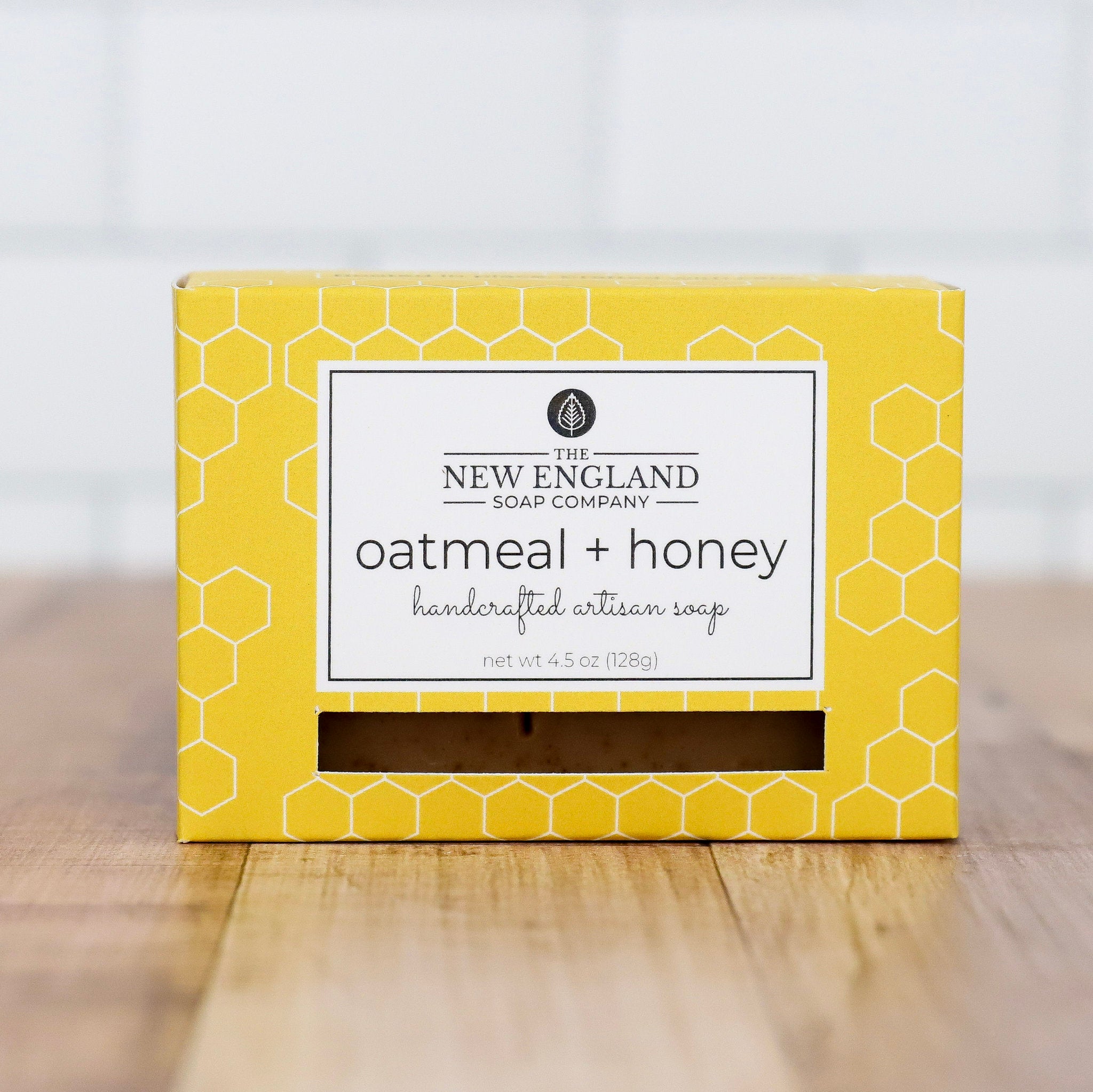 Yellow box of New England Soap Company oatmeal and honey soap on a wooden surface