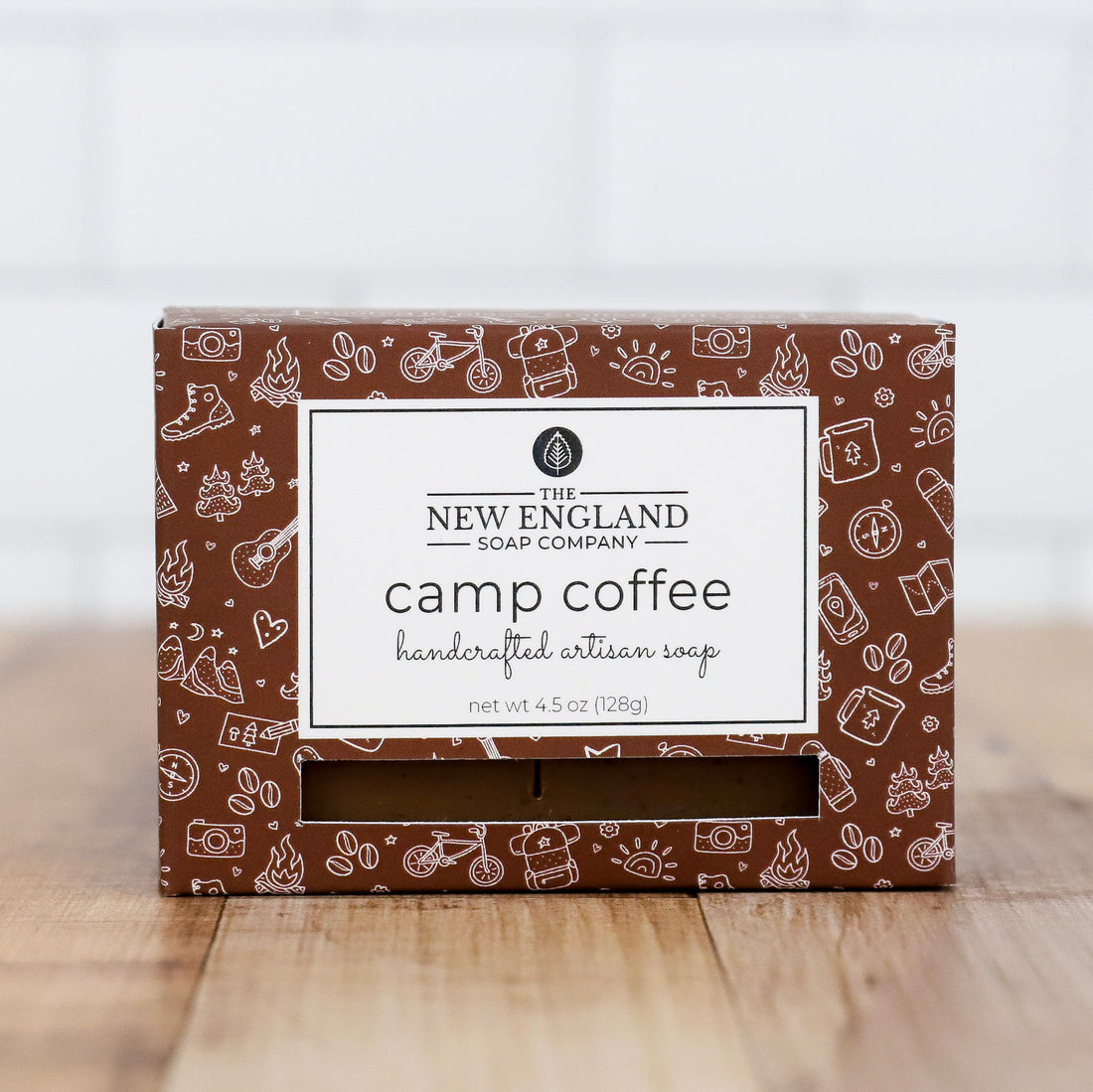 Box of New England Soap Company camp coffee soap on a wooden surface with a white background