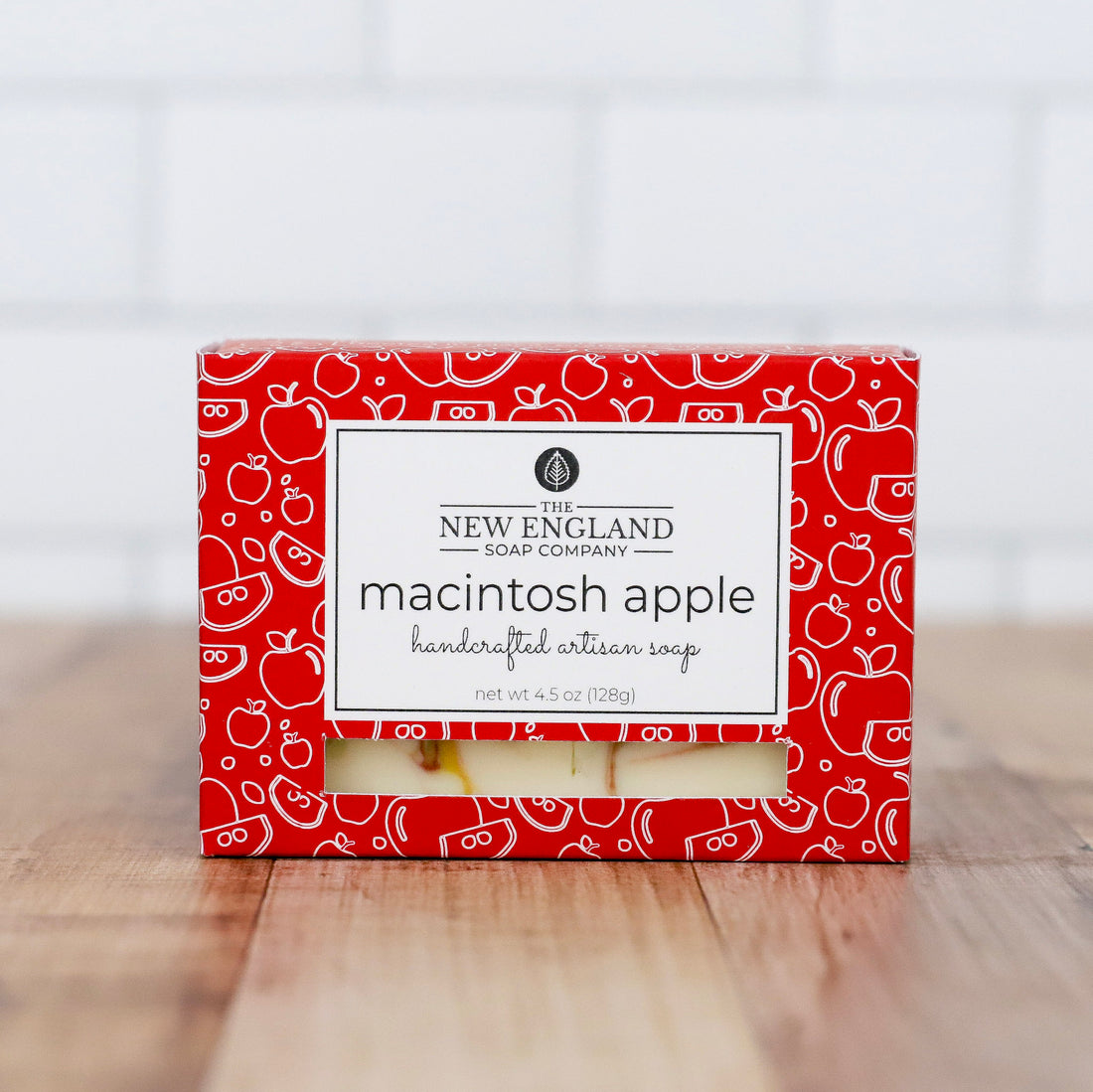 Box of New England Soap Company Macintosh Apple soap on a wooden surface with a white background