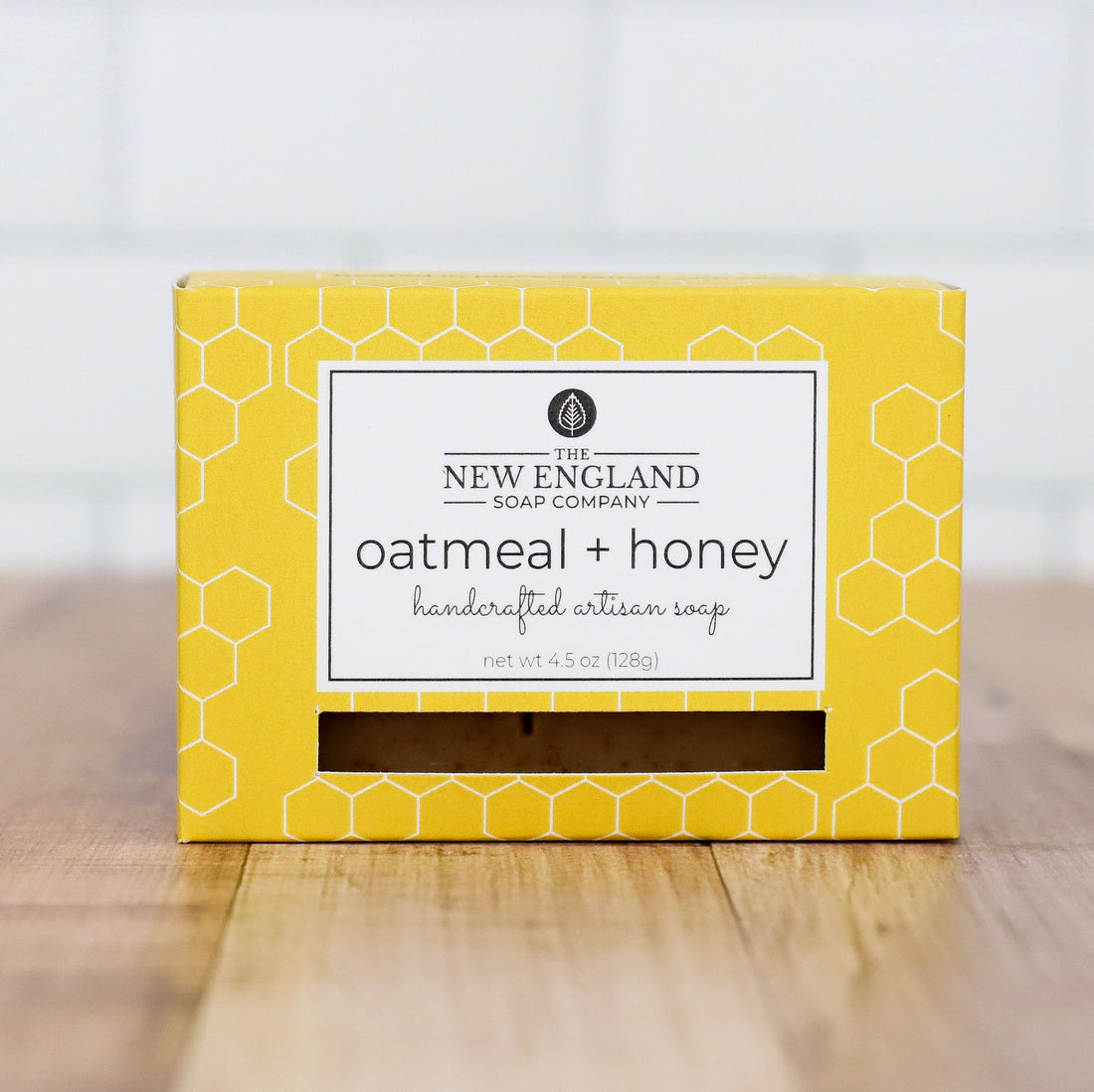Yellow box of New England Soap Company oatmeal and honey soap on a wooden surface